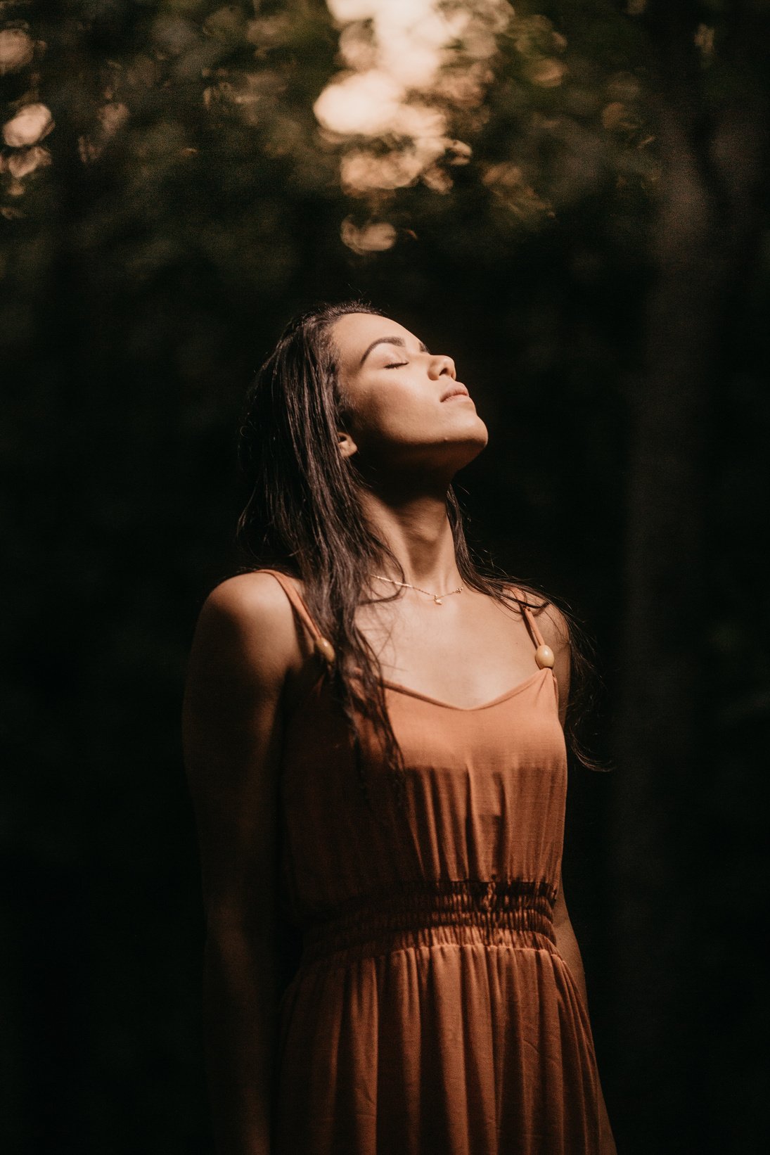 Mindful ethnic woman in elegant apparel at dusk